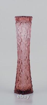 Art glass vase, Central Europe. Tall and slim vase in purple glass