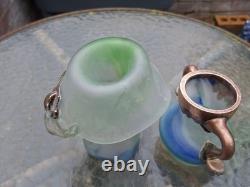 Verre d’atelier avec recouvrement en cuivre massif. Deux pièces signées par l’artiste