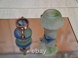 Verre d’atelier avec recouvrement en cuivre massif. Deux pièces signées par l’artiste